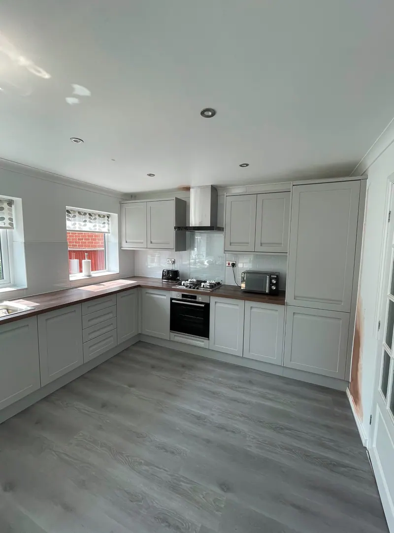 Grey shaker kitchen with wood-effect flooring