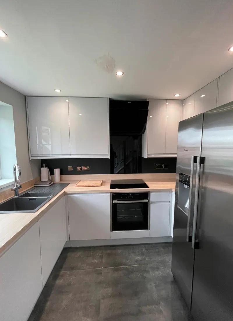 White gloss kitchen with American-style fridge freezer